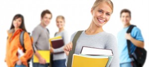 Exercise science student holding her kinesiology books and backpack.