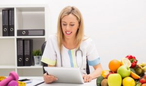 Certified health coach with nursing background teaching her client healthy behavior change habits.