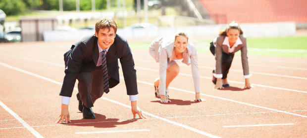 Students studying sports management lining up on a running track.
