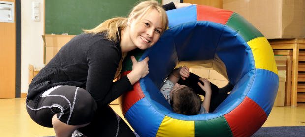 Female art therapist working with a child.